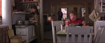 Movie still from “This Boy's Life” (1993), directed by Michael Caton-Jones – Two children in a kitchen preparing a meal; Medium shot, Low angle