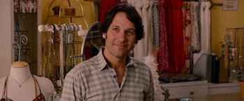 Movie still from “This Is 40” (2012), directed by Judd Apatow – A man standing in front of a rack of clothes; Close Up shot, Over the shoulder angle