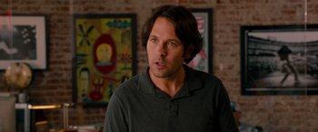 Movie still from “This Is 40” (2012), directed by Judd Apatow – A man that is standing in front of a wall; Close Up shot, Over the shoulder angle