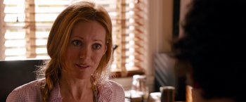 Movie still from “This Is 40” (2012), directed by Judd Apatow – A person sitting at a table; Close Up shot, Over the shoulder angle