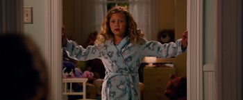 Movie still from “This Is 40” (2012), directed by Judd Apatow – A young girl in a blue robe in a living room; Medium shot, High angle