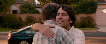 Movie still from “This Is 40” (2012), directed by Judd Apatow – Two men hugging each other in a yard; Close Up shot, Over the shoulder angle