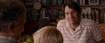 Movie still from “This Is 40” (2012), directed by Judd Apatow – A man sitting in front of a boy with a teddy bear; Close Up shot, Over the shoulder angle