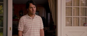 Movie still from “This Is 40” (2012), directed by Judd Apatow – A man standing in front of a window; Medium shot, Over the shoulder angle