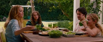 Movie still from “This Is 40” (2012), directed by Judd Apatow – A woman sitting at a table with a bowl of salad; Medium shot, Over the shoulder angle