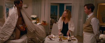 Movie still from “This Is 40” (2012), directed by Judd Apatow – A woman standing at a table in a room; Medium shot, Over the shoulder angle