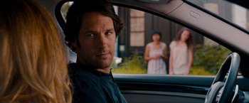 Movie still from “This Is 40” (2012), directed by Judd Apatow – A man sitting in the back seat of a car; Close Up shot, Over the shoulder angle
