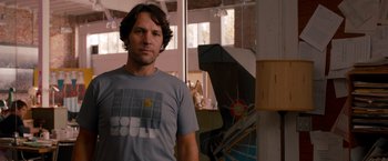 Movie still from “This Is 40” (2012), directed by Judd Apatow – A man standing in front of a mirror in a room; Medium shot, Over the shoulder angle