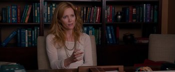 Movie still from “This Is 40” (2012), directed by Judd Apatow – A woman sitting in front of a book shelf; Medium shot, Over the shoulder angle