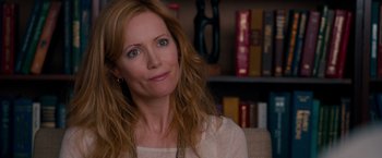 Movie still from “This Is 40” (2012), directed by Judd Apatow – A person sitting in front of a bookshelf; Close Up shot, Over the shoulder angle