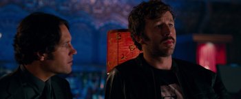 Movie still from “This Is 40” (2012), directed by Judd Apatow – A man and a woman standing next to each other in a room; Close Up shot, Over the shoulder angle