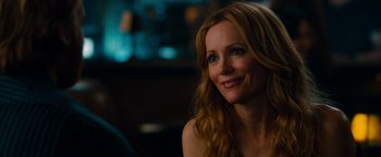 Movie still from “This Is 40” (2012), directed by Judd Apatow – A woman sitting in front of a camera smiling for the camera; Close Up shot, Over the shoulder angle
