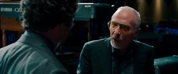 Movie still from “This Is 40” (2012), directed by Judd Apatow – An older man in a suit talking to a younger man; Close Up shot, Over the shoulder angle