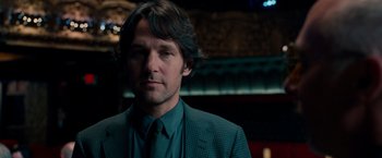 Movie still from “This Is 40” (2012), directed by Judd Apatow – A person wearing a suit and tie; Close Up shot, Over the shoulder angle