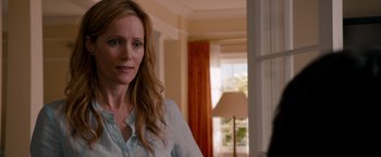 Movie still from “This Is 40” (2012), directed by Judd Apatow – A woman standing in front of a window in a room; Close Up shot, Over the shoulder angle