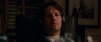 Movie still from “This Is 40” (2012), directed by Judd Apatow – A person wearing headphones; Close Up shot, High angle
