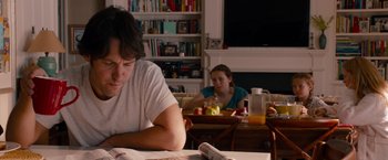 Movie still from “This Is 40” (2012), directed by Judd Apatow – A man and a woman sitting at a dining room table; Medium shot, Over the shoulder angle