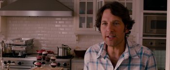 Movie still from “This Is 40” (2012), directed by Judd Apatow – A man standing in front of a stove in a kitchen; Close Up shot, Over the shoulder angle