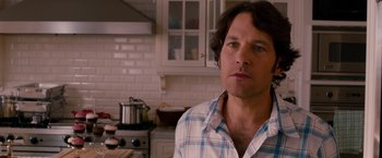 Movie still from “This Is 40” (2012), directed by Judd Apatow – A person standing in a kitchen; Close Up shot, Over the shoulder angle