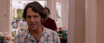 Movie still from “This Is 40” (2012), directed by Judd Apatow – A person wearing a plaid shirt; Close Up shot, Over the shoulder angle