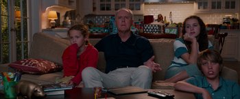 Movie still from “This Is 40” (2012), directed by Judd Apatow – An older man sitting next to a young girl; Medium shot, Over the shoulder angle