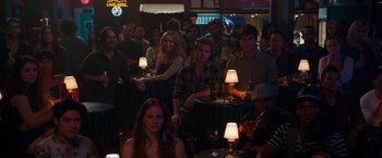 Movie still from “This Is 40” (2012), directed by Judd Apatow – A group of people sitting around a bar; Wide shot, High angle