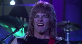 Movie still from “This Is Spinal Tap” (1984), directed by Rob Reiner – A person wearing a wig; Close Up shot, Low angle