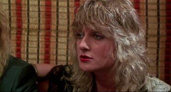 Movie still from “This Is Spinal Tap” (1984), directed by Rob Reiner – A person with long blonde hair; Close Up shot, Low angle