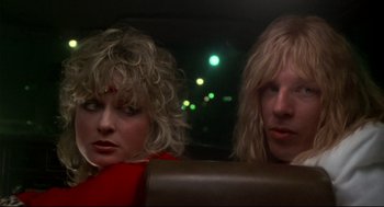 Movie still from “This Is Spinal Tap” (1984), directed by Rob Reiner – A couple of people sitting in the back of a car; Close Up shot, Over the shoulder angle