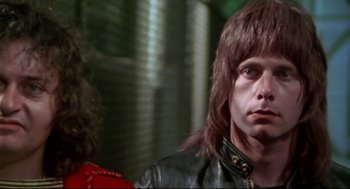 Movie still from “This Is Spinal Tap” (1984), directed by Rob Reiner – A person wearing a leather jacket; Close Up shot, Low angle