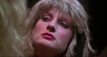 Movie still from “This Is Spinal Tap” (1984), directed by Rob Reiner – A person wearing a wig; Close Up shot, Low angle