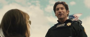 Movie still from “Those Who Wish Me Dead” (2021), directed by Taylor Sheridan – A man and a woman standing next to each other in front of a sky background; Close Up shot, Over the shoulder angle