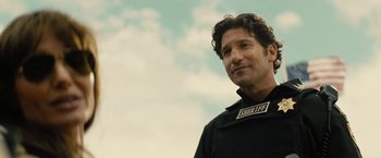 Movie still from “Those Who Wish Me Dead” (2021), directed by Taylor Sheridan – A person wearing a black jacket; Close Up shot, Over the shoulder angle