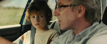 Movie still from “Those Who Wish Me Dead” (2021), directed by Taylor Sheridan – A man and a boy sitting in the back of a car; Close Up shot, Over the shoulder angle