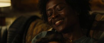 Movie still from “Those Who Wish Me Dead” (2021), directed by Taylor Sheridan – A person smiling with her eyes closed; Close Up shot, High angle