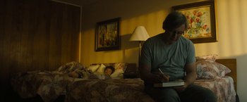 Movie still from “Those Who Wish Me Dead” (2021), directed by Taylor Sheridan – A man sitting on a bed next to a woman; Medium shot, Low angle