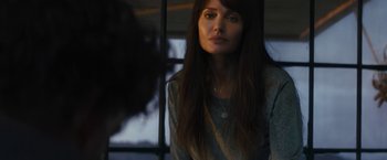 Movie still from “Those Who Wish Me Dead” (2021), directed by Taylor Sheridan – A woman with long dark brown hair wearing a gray shirt; Close Up shot, Over the shoulder angle