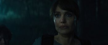 Movie still from “Those Who Wish Me Dead” (2021), directed by Taylor Sheridan – A person wearing a necklace; Close Up shot, Over the shoulder angle