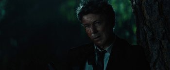 Movie still from “Those Who Wish Me Dead” (2021), directed by Taylor Sheridan – A person wearing a suit and tie; Close Up shot, Over the shoulder angle