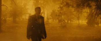 Movie still from “Those Who Wish Me Dead” (2021), directed by Taylor Sheridan – A man walking through a foggy forest with trees in the background; Wide shot, Low angle