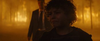Movie still from “Those Who Wish Me Dead” (2021), directed by Taylor Sheridan – A woman with curly hair is crying in a dark room; Close Up shot, Over the shoulder angle