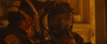Movie still from “Those Who Wish Me Dead” (2021), directed by Taylor Sheridan – A man in a helmet is looking at the camera; Close Up shot, Over the shoulder angle