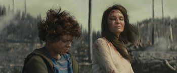Movie still from “Those Who Wish Me Dead” (2021), directed by Taylor Sheridan – A woman with blood all over her face and a man with blood all over his face; Medium shot, Over the shoulder angle