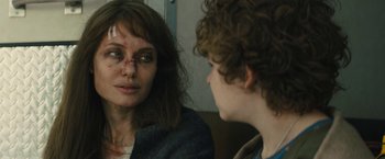 Movie still from “Those Who Wish Me Dead” (2021), directed by Taylor Sheridan – A woman and a boy looking at one another in a mirror; Close Up shot, Over the shoulder angle