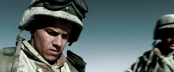 Movie still from “Three Kings” (1999), directed by David O. Russell – A man wearing a helmet and goggles is looking down at the sky; Close Up shot, Low angle