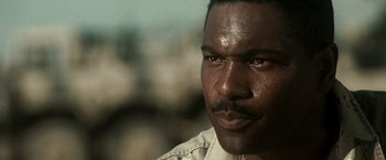 Movie still from “Three Kings” (1999), directed by David O. Russell – A man's face with a lot of water on his face; Close Up shot, Low angle