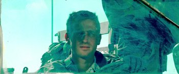 Movie still from “Three Kings” (1999), directed by David O. Russell – A man in a military fatigues sitting in a vehicle; Close Up shot, Low angle
