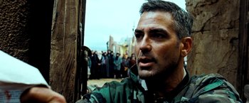 Movie still from “Three Kings” (1999), directed by David O. Russell – A person with a crowd in the background; Close Up shot, Low angle