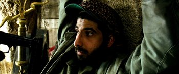 Movie still from “Three Kings” (1999), directed by David O. Russell – A person wearing a hat; Close Up shot, Overhead angle