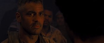 Movie still from “Three Kings” (1999), directed by David O. Russell – A person in a dark room; Close Up shot, Over the shoulder angle